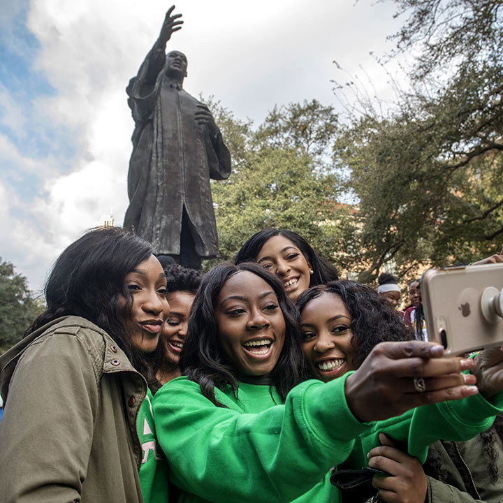 Attendees at an annual Martin Luther King, Jr. Day march take a selfie at The University of Texas at Austin
