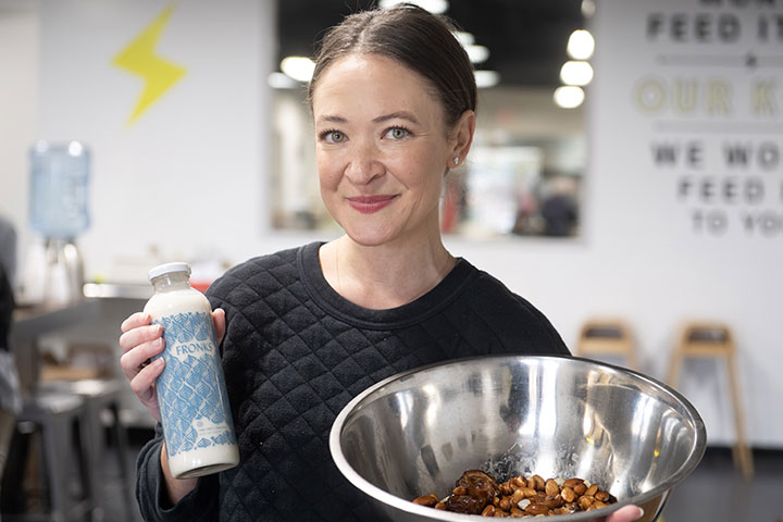 Fronks founder Jordan Fronk holds a bottle of almond-cashew milk