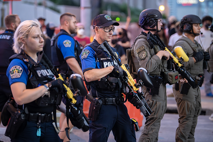 police confront protesters during a solidarity with Los Angeles protest against ICE near Austin's federal building