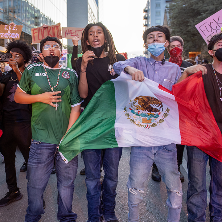 police confront protesters during a solidarity with Los Angeles protest against ICE near Austin's federal building
