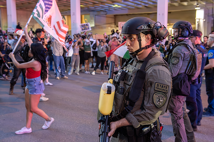 police confront protesters during a solidarity with Los Angeles protest against ICE near Austin's federal building