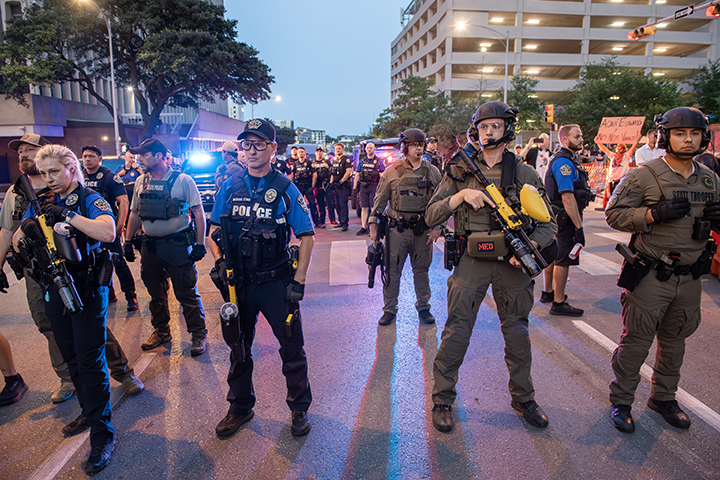police confront protesters during a solidarity with Los Angeles protest against ICE near Austin's federal building