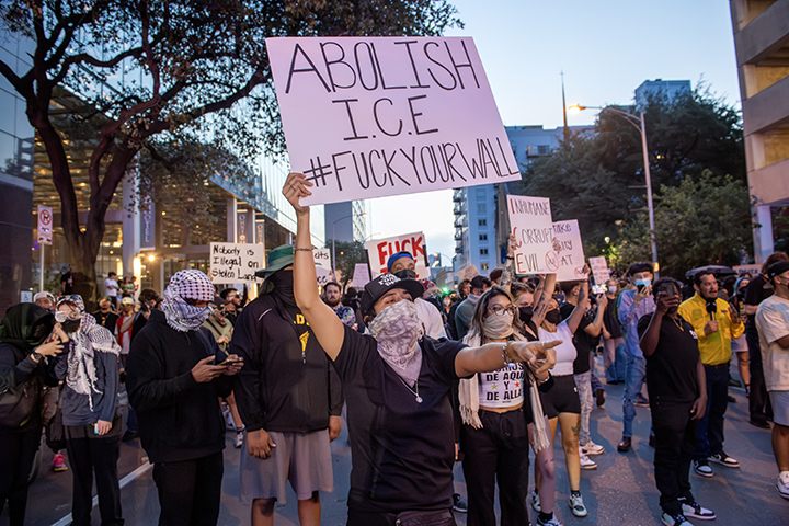 police confront protesters during a solidarity with Los Angeles protest against ICE near Austin's federal building