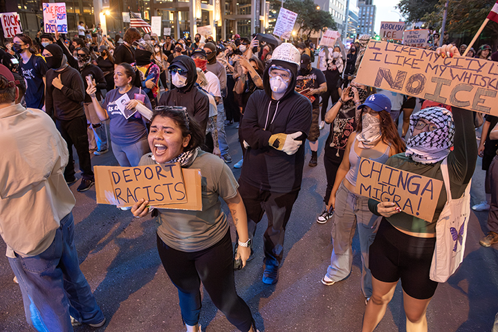 police confront protesters during a solidarity with Los Angeles protest against ICE near Austin's federal building
