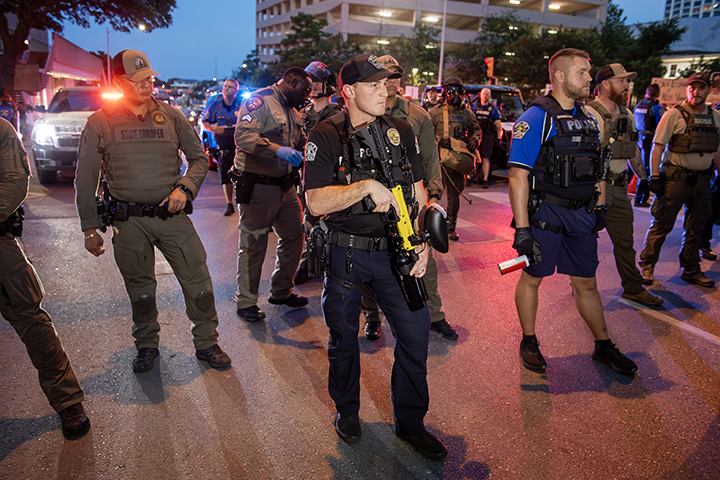 police confront protesters during a solidarity with Los Angeles protest against ICE near Austin's federal building