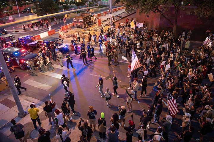 police confront protesters during a solidarity with Los Angeles protest against ICE near Austin's federal building