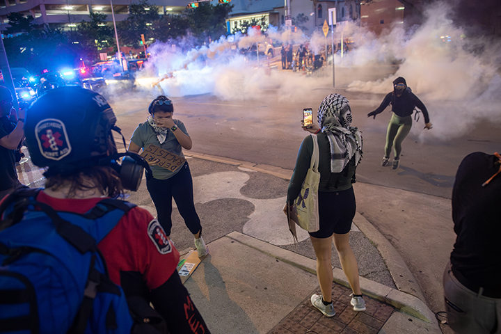 protesters run from tear gas during a solidarity with Los Angeles protest against ICE near Austin's federal building on June 9, 2025