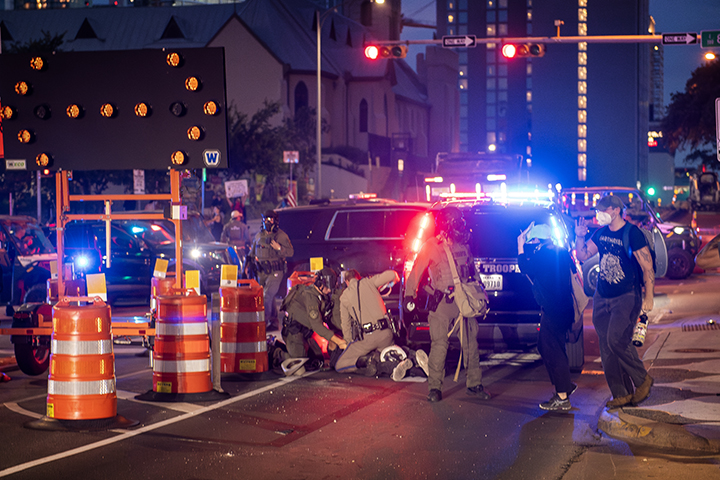 protesters run from tear gas during a solidarity with Los Angeles protest against ICE near Austin's Federal building on June 9, 2025