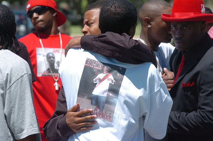 Mourners embrace before funeral services for 17-year-old Nathaniel Sanders