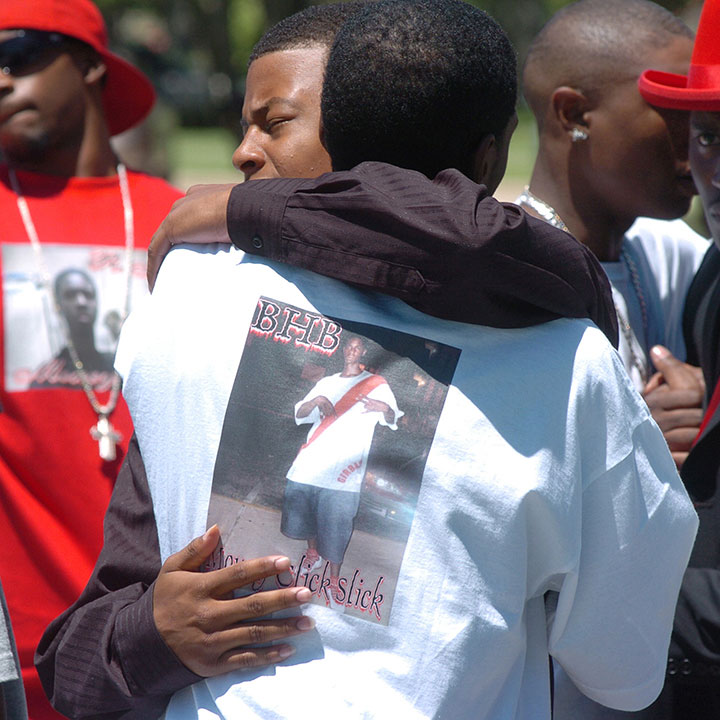 Mourners embrace before funeral services for 17-year-old Nathaniel Sanders. Sanders was fatally shot by an Austin Police Department officer during a traffic stop.