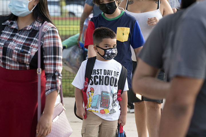 Students arrive at Sanchez Elementary School for the first day of school 