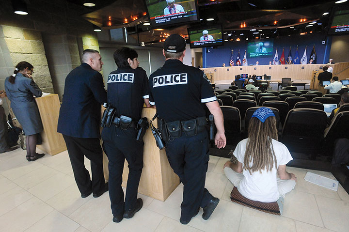 A small group of protesters refuse to move from the Austin City Hall plaza steps for pressure washing and were arrested for criminal trespassing in the early morning hours