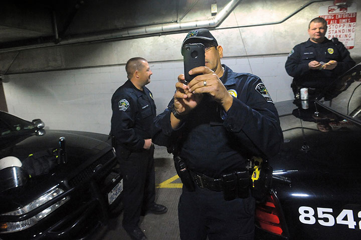 Police gather in the parking lot beneath City Hall in Austin, a day after Occupy Austin’s eviction from the City Hall plaza