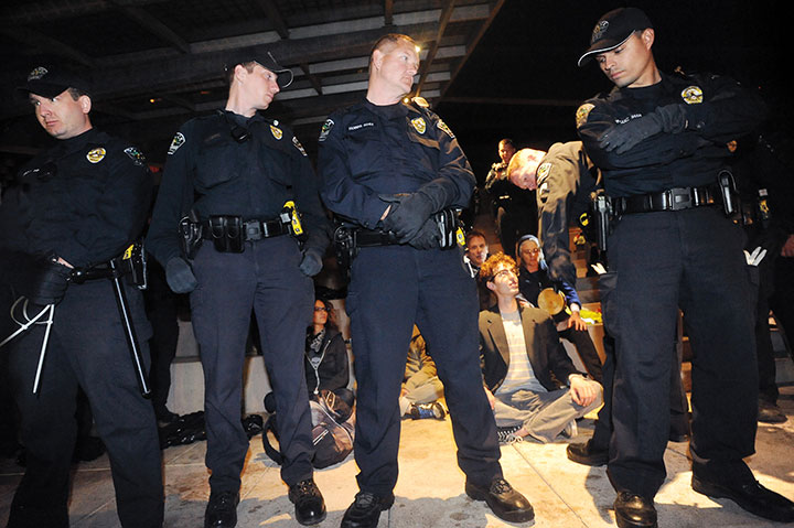 A small group of protesters refuse to move from the Austin City Hall plaza steps for pressure washing and were arrested for criminal trespassing in the early morning hours