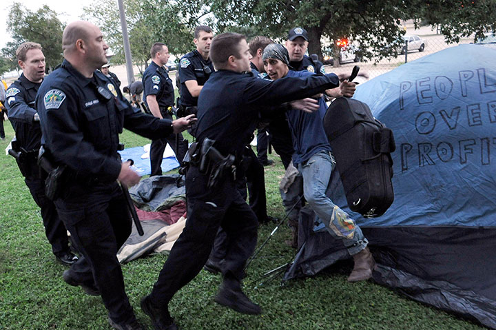 A participant is arrested for pitching a tent outside an abandoned Home Depot