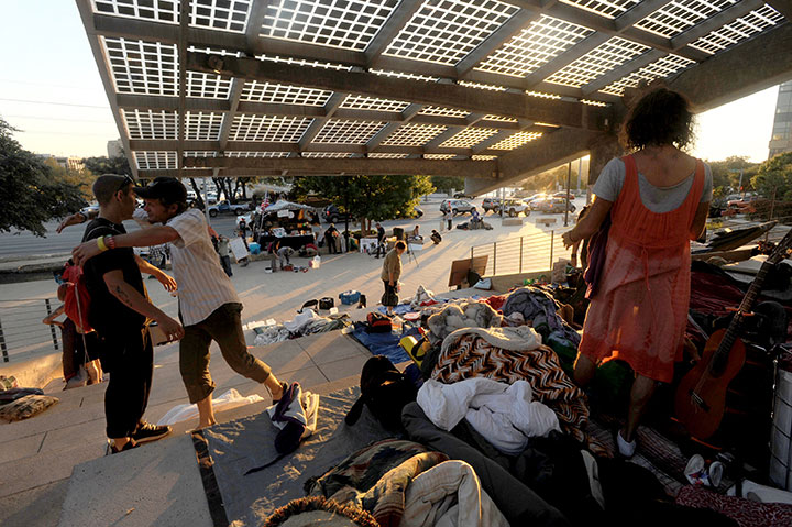 Two Occupy Austin participants embrace on City Hall plaza