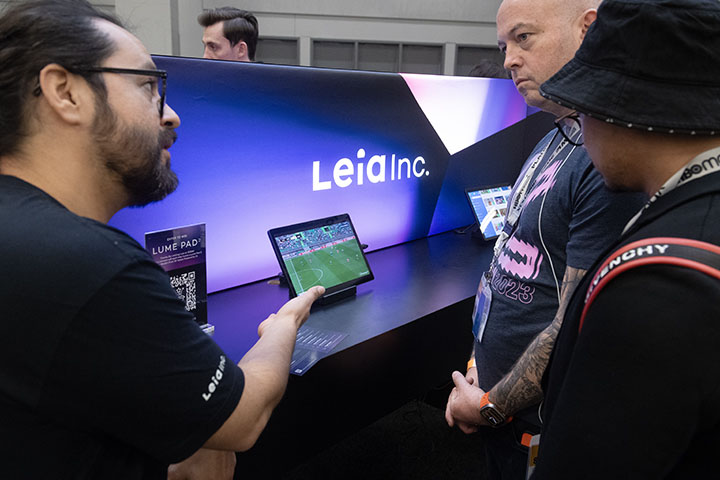 A representative from Leia Inc. (left) talks to attendees about the company’s Lume Pad 2 at the Creative Industries Expo during South By Southwest 2023 in Austin, Texas, March 12, 2023